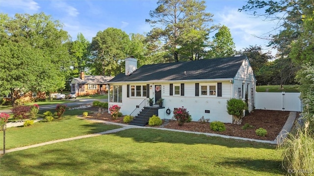 ranch-style home with a chimney and a gate