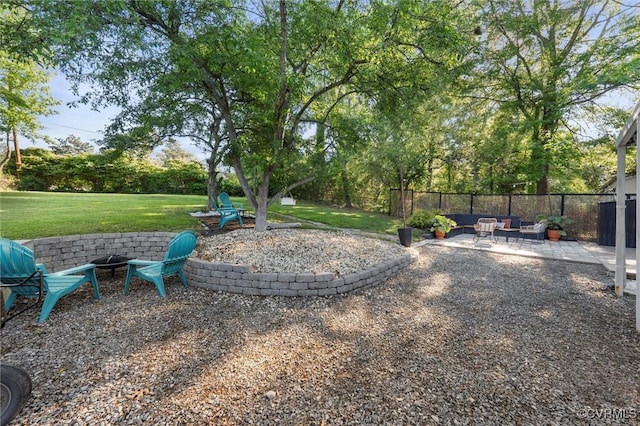 view of yard with an outdoor living space with a fire pit and a patio