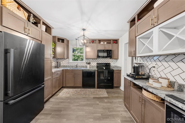kitchen featuring open shelves, black appliances, a sink, and tasteful backsplash