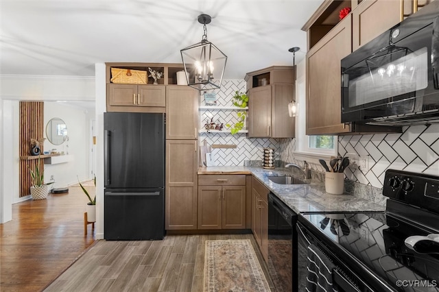 kitchen featuring black appliances, open shelves, a sink, tasteful backsplash, and light wood-style flooring