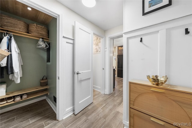 mudroom featuring light wood-type flooring and baseboards