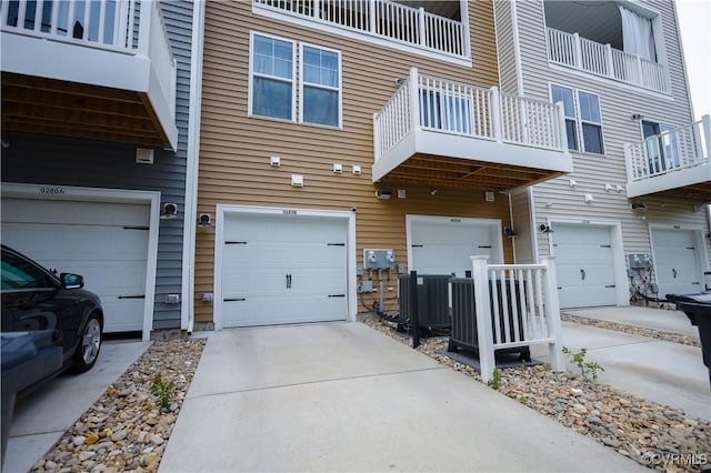 exterior space featuring an attached garage and central AC