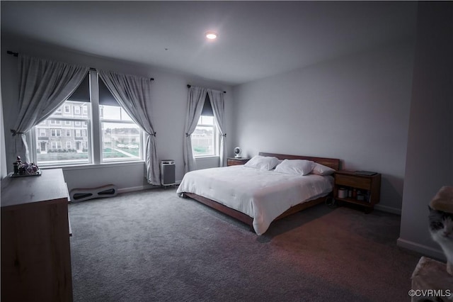 carpeted bedroom featuring baseboards