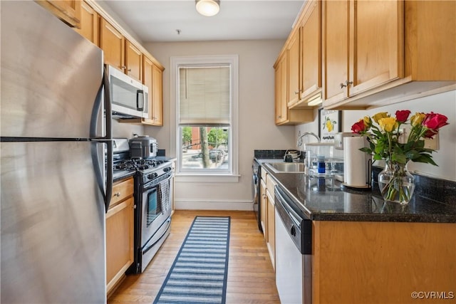 317 N 2nd St Unit B, Richmond, VA 23219 - kitchen featuring appliances with stainless steel finishes, a sink, light wood finished floors, and baseboards