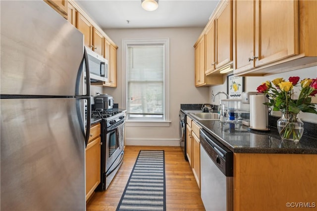 317 N 2nd St Unit B, Richmond, VA 23219 - kitchen featuring stainless steel appliances, a sink, light wood-type flooring, and baseboards