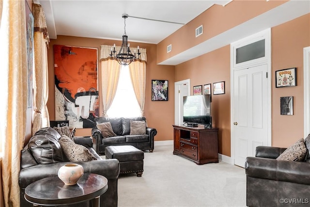 carpeted living area with a chandelier and baseboards