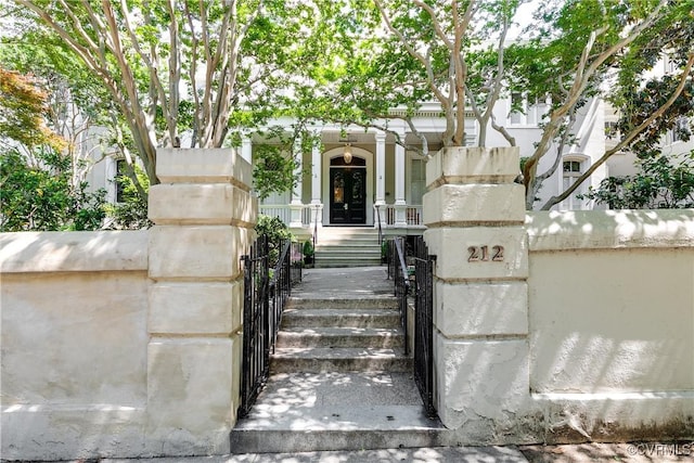 doorway to property featuring a gate and fence