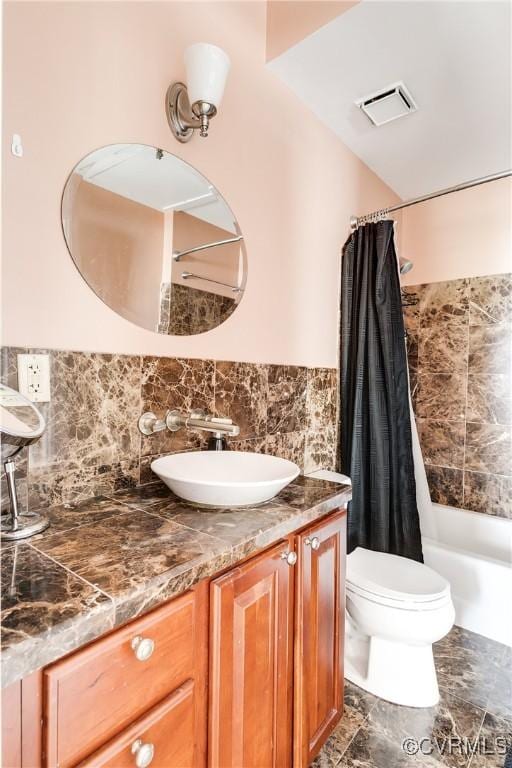 bathroom featuring vanity, toilet, and shower / bath combination with curtain