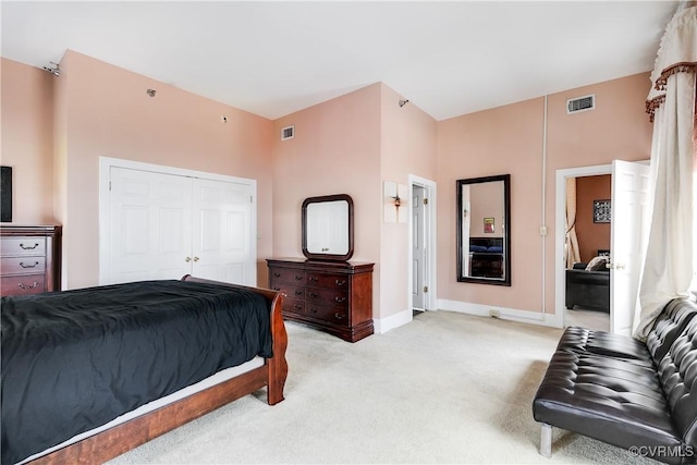 bedroom featuring light carpet, baseboards, and a closet