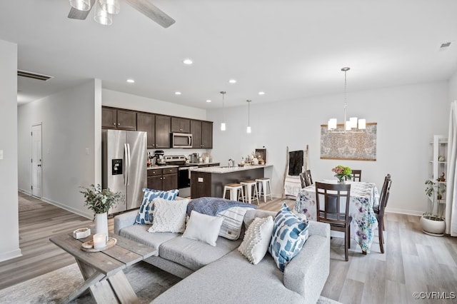 11348 Benton Pointe Way, Chester, VA 23831 - living room featuring light wood-style floors, recessed lighting, baseboards, ceiling fan, and a chandelier
