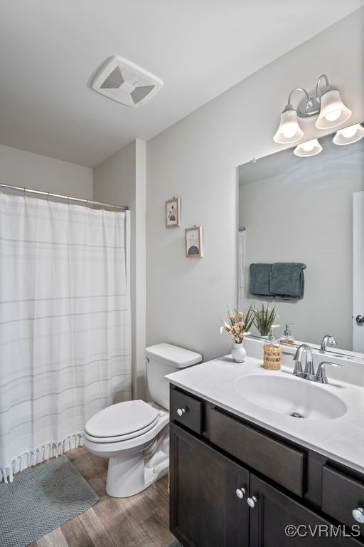 11348 Benton Pointe Way, Chester, VA 23831 - bathroom featuring vanity, toilet, and wood finished floors