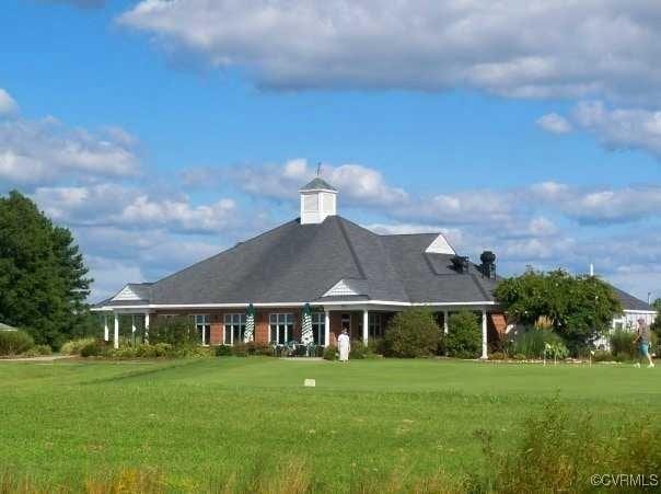 rear view of house with a lawn
