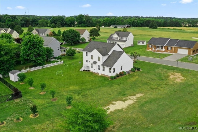 aerial view of residential area featuring a tree filled landscape