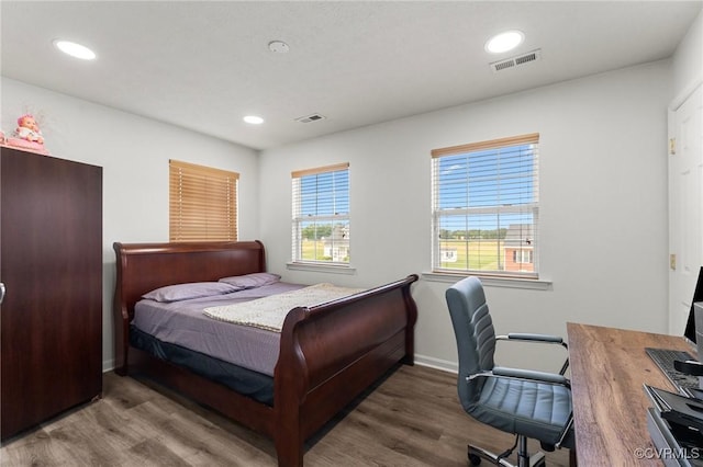 bedroom with wood finished floors, recessed lighting, an office area, and baseboards