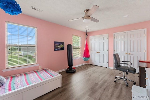 office with wood finished floors, baseboards, and a ceiling fan