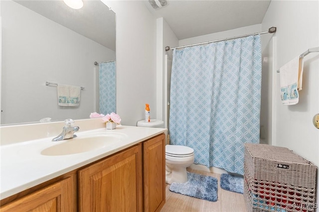 full bathroom featuring toilet, vanity, and curtained shower