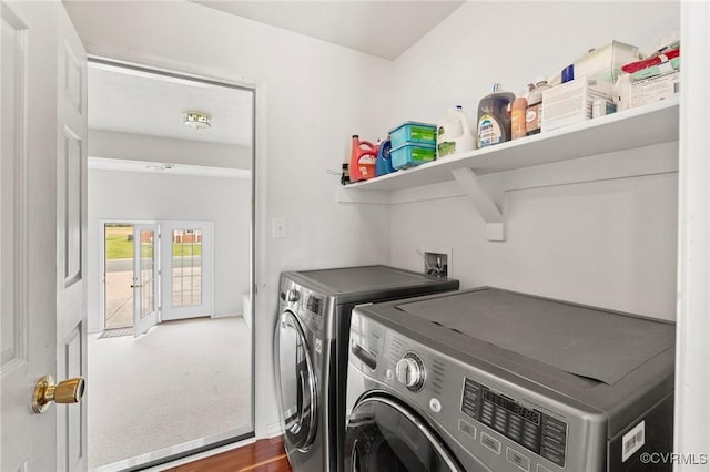 washroom featuring washing machine and clothes dryer, wood finished floors, and baseboards