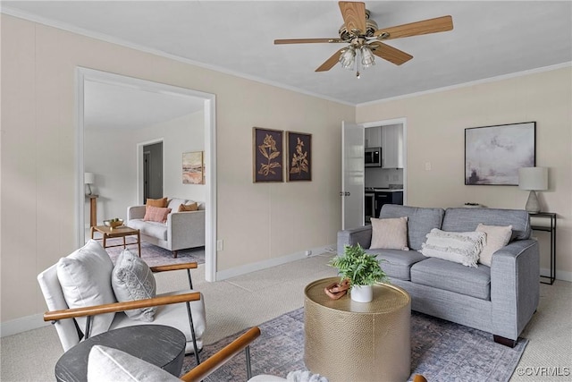 carpeted living room with ceiling fan, crown molding, and baseboards