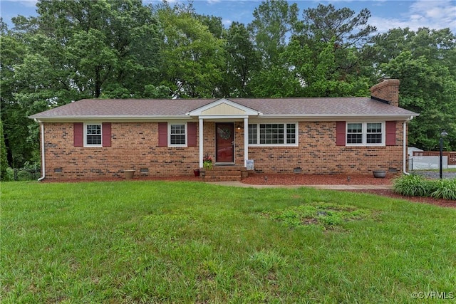 ranch-style house featuring crawl space, a front lawn, a chimney, and brick siding