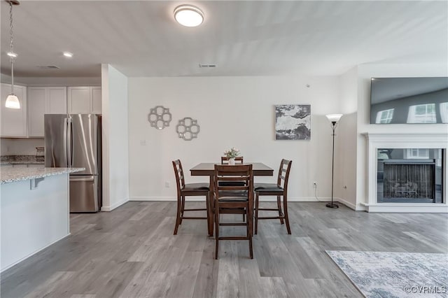 12106 Oxford Landing Dr Unit 202, Glen Allen, VA 23059 - dining room featuring wood finished floors, baseboards, recessed lighting, and a fireplace