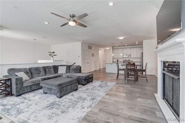 12106 Oxford Landing Dr Unit 202, Glen Allen, VA 23059 - living room featuring a fireplace, a ceiling fan, light wood finished floors, and recessed lighting
