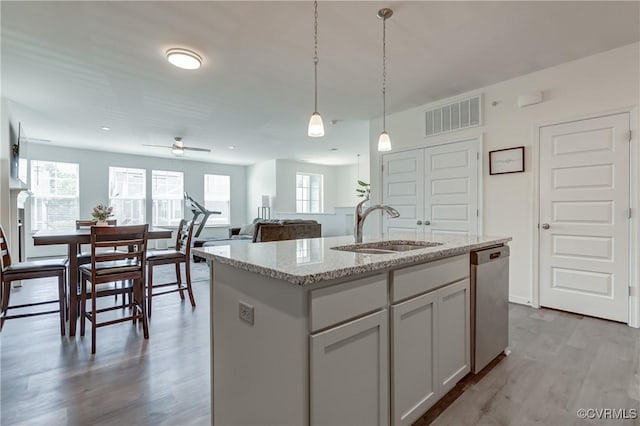 12106 Oxford Landing Dr Unit 202, Glen Allen, VA 23059 - kitchen with a sink, dishwasher, wood finished floors, decorative light fixtures, and light stone countertops