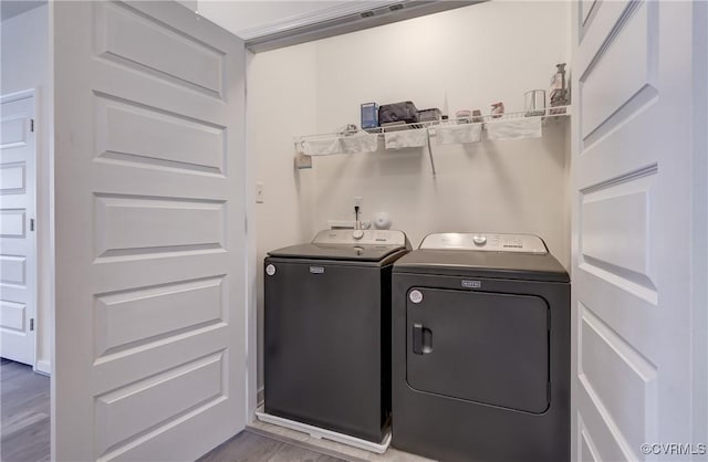 12106 Oxford Landing Dr Unit 202, Glen Allen, VA 23059 - washroom with washer and dryer and wood finished floors