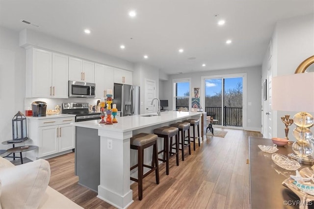 5234 Old Main St Unit C, Henrico, VA 23231 - kitchen featuring stainless steel appliances, a sink, an island with sink, light wood-type flooring, and recessed lighting