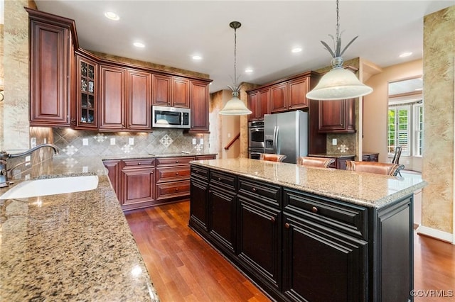 6306 Thistledew Mews, Moseley, VA 23120 - kitchen with appliances with stainless steel finishes, a sink, dark wood-type flooring, a center island, and recessed lighting