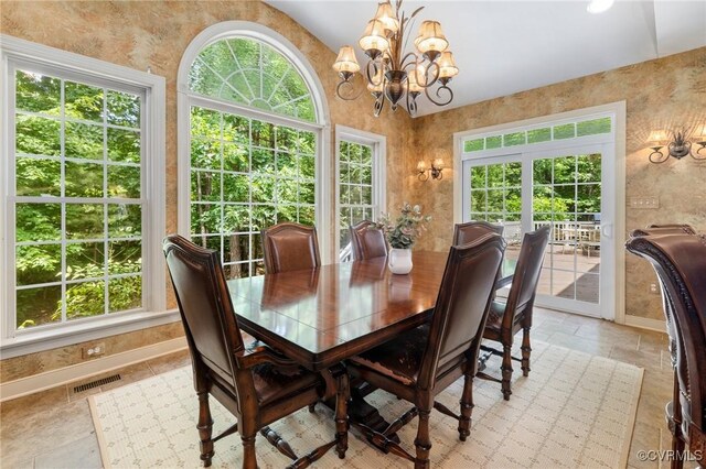 6306 Thistledew Mews, Moseley, VA 23120 - dining room with a chandelier, vaulted ceiling, light stone finish flooring, and baseboards