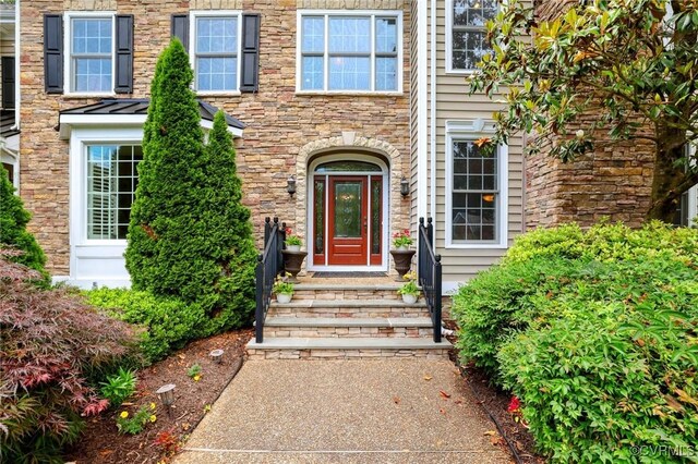 6306 Thistledew Mews, Moseley, VA 23120 - doorway to property featuring stone siding and a standing seam roof