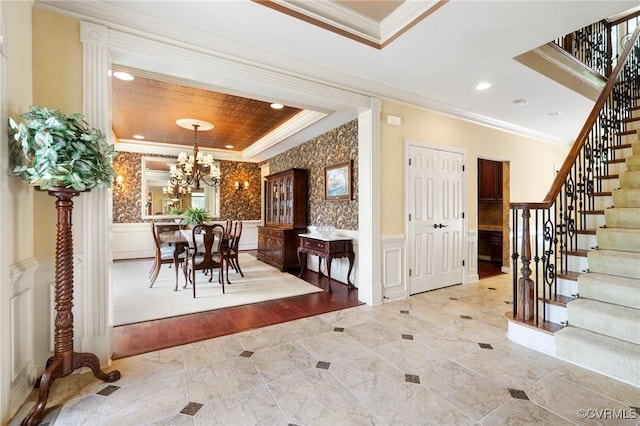 6306 Thistledew Mews, Moseley, VA 23120 - entryway featuring ornamental molding, stairway, a raised ceiling, a chandelier, and a decorative wall