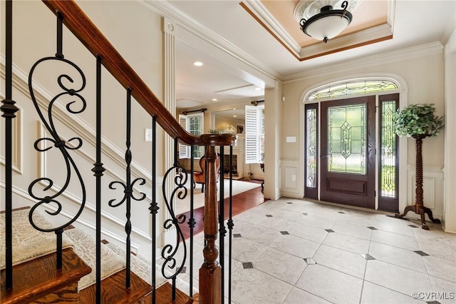 6306 Thistledew Mews, Moseley, VA 23120 - entrance foyer with light tile patterned floors, a decorative wall, stairs, crown molding, and a wainscoted wall