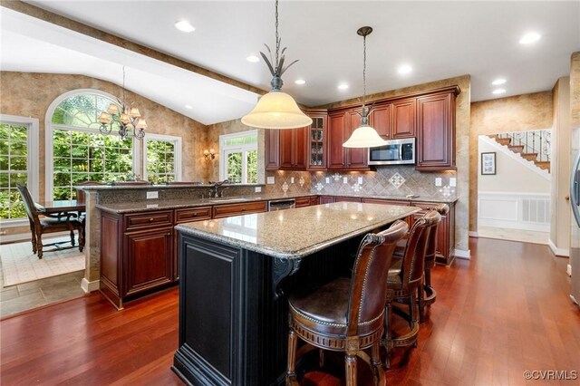 6306 Thistledew Mews, Moseley, VA 23120 - kitchen featuring stainless steel appliances, lofted ceiling, a kitchen island, dark wood finished floors, and a peninsula