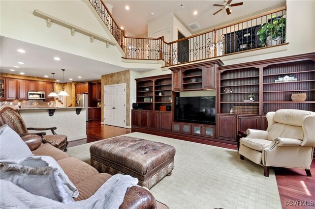 6306 Thistledew Mews, Moseley, VA 23120 - living room with a towering ceiling, recessed lighting, stairs, a ceiling fan, and dark wood-type flooring
