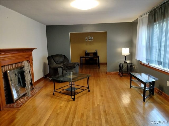 724 Milton Dr, Hampton, VA 23666 - living area featuring wood finished floors, a chandelier, and a fireplace