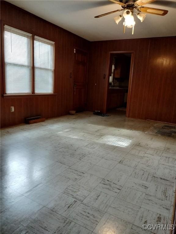 724 Milton Dr, Hampton, VA 23666 - empty room with a ceiling fan, wooden walls, and tile patterned floors