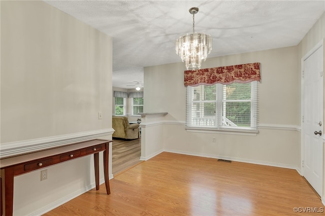9865 Knobs Hill Ln, Amelia, VA 23002 - unfurnished dining area with light wood-style flooring and a chandelier