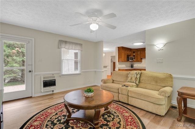 9865 Knobs Hill Ln, Amelia, VA 23002 - living room with heating unit, plenty of natural light, light wood-style floors, a ceiling fan, and a textured ceiling