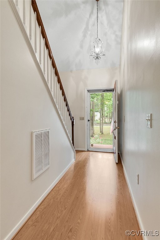 9865 Knobs Hill Ln, Amelia, VA 23002 - foyer with wood finished floors, stairway, and a chandelier