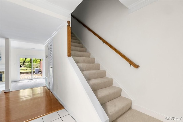 stairway featuring ornamental molding
