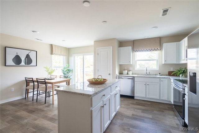 2124 Grand Reserve Way Unit N-1, Henrico, VA 23223 - kitchen with stainless steel appliances, a sink, light stone countertops, a center island, and dark wood-type flooring