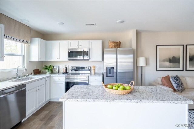 2124 Grand Reserve Way Unit N-1, Henrico, VA 23223 - kitchen featuring stainless steel appliances, a sink, light stone countertops, and white cabinets