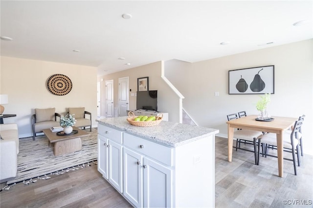 2124 Grand Reserve Way Unit N-1, Henrico, VA 23223 - kitchen featuring light wood finished floors, open floor plan, white cabinetry, light stone counters, and recessed lighting