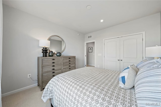 bedroom with light colored carpet, a closet, baseboards, and recessed lighting