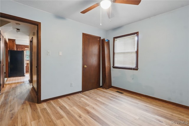 4501 Roxbury Rd, Charles City, VA 23030 - unfurnished bedroom with freestanding refrigerator, baseboards, light wood-type flooring, and a closet