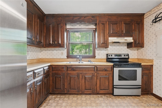 4501 Roxbury Rd, Charles City, VA 23030 - kitchen featuring stainless steel appliances, a sink, under cabinet range hood, light countertops, and wallpapered walls