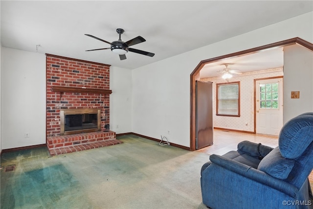 4501 Roxbury Rd, Charles City, VA 23030 - carpeted living area with a ceiling fan, a fireplace, baseboards, and arched walkways