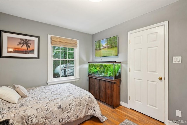 bedroom featuring wood finished floors and baseboards