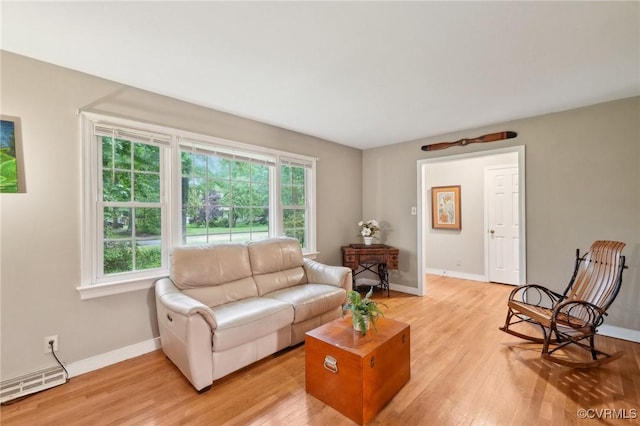 living area with baseboards and light wood-type flooring
